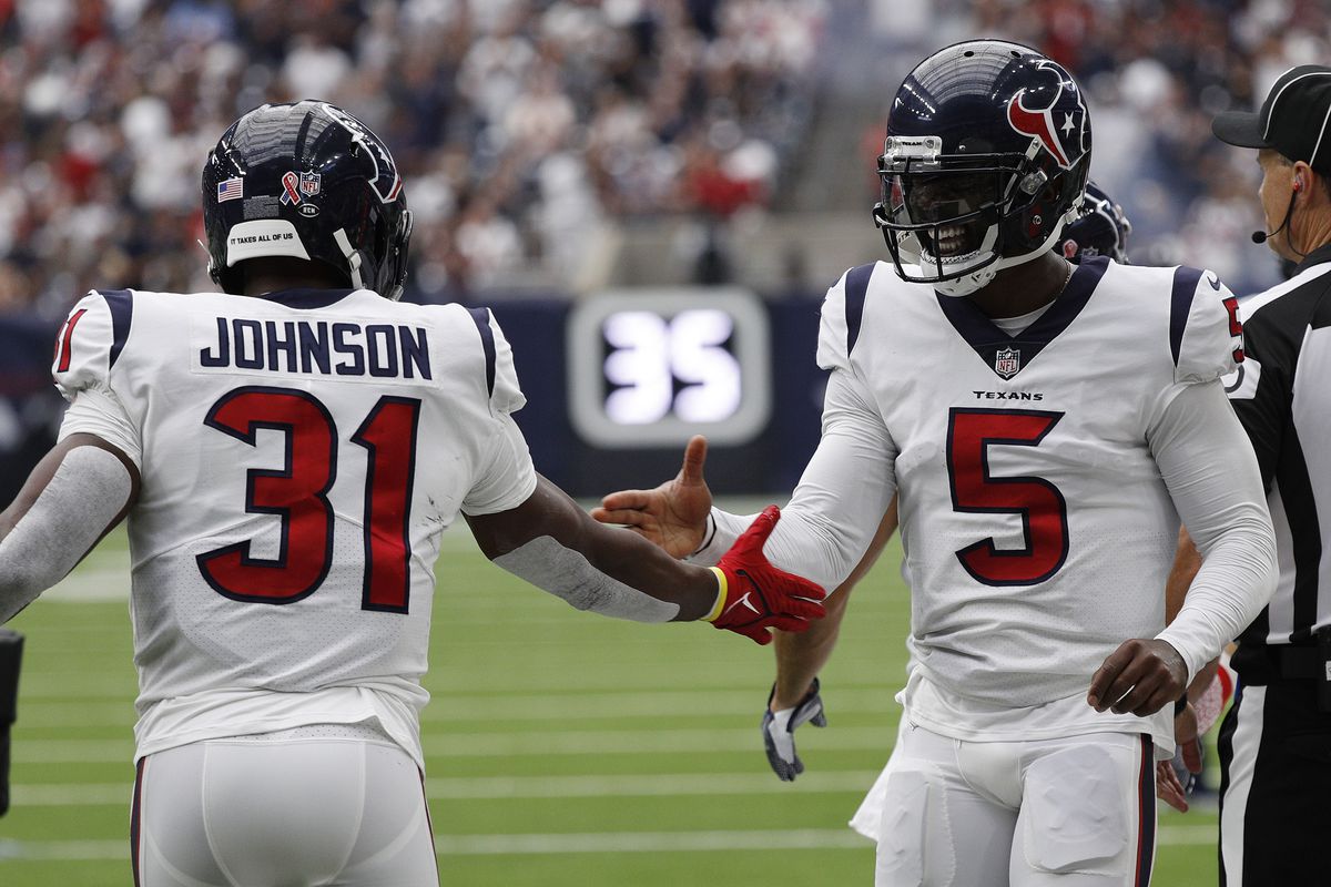 Tyrod Taylor #5 of the Houston Texans celebrates with David Johnson #31 after his touchdown against the Jacksonville Jaguars during the first quarter at NRG Stadium on September 12, 2021 in Houston, Texas.