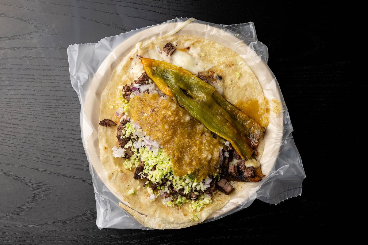A carne asada taco topped with chile.
