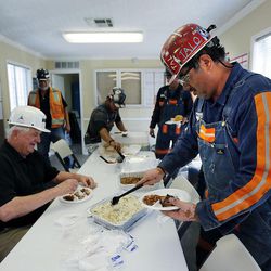 Natalio Lerma, right, dishes up some food while eating lunch at Burton No. 1 mine in Alton, Thursday, Aug. 20, 2015. At left is Bob Nead, an owner of Alton Coal Development.