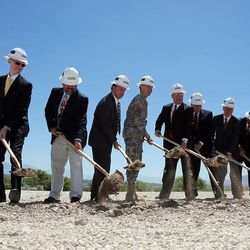 Dignitaries shovel dirt during the groundbreaking ceremony for Sunrise Hall, a worship center at Camp Williams, Wednesday, June 5, 2013.