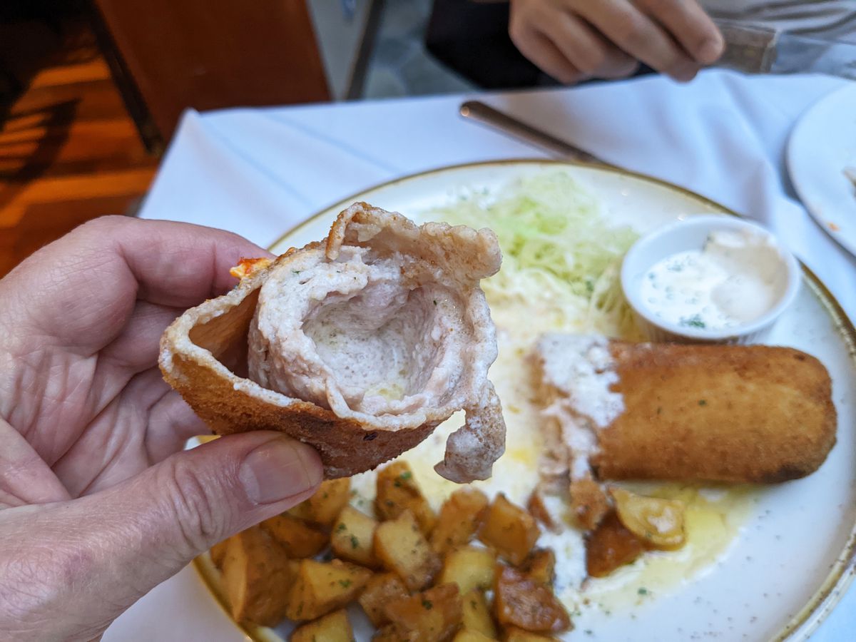 The same schnitzel cut in half to reveal oozing white center.