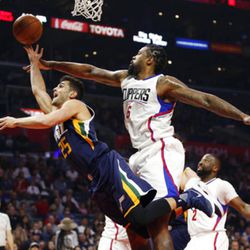 Los Angeles Clippers center DeAndre Jordan, right, fouls Utah Jazz guard Raul Neto, left, as he goes to the basket during the first half of an NBA basketball game, Saturday, March 25, 2017, in Los Angeles. (AP Photo/Danny Moloshok)