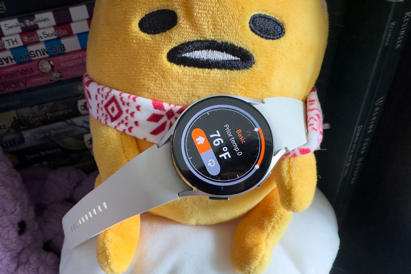 Samsung Galaxy Watch 6 showing the Thermo Check app on a Gudetama plushie.