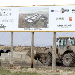 A loader works near the entrance leading to the construction site for the new Utah State Correctional Facility at 1480 N. 8000 West in Salt Lake City on Friday, April 5, 2019.