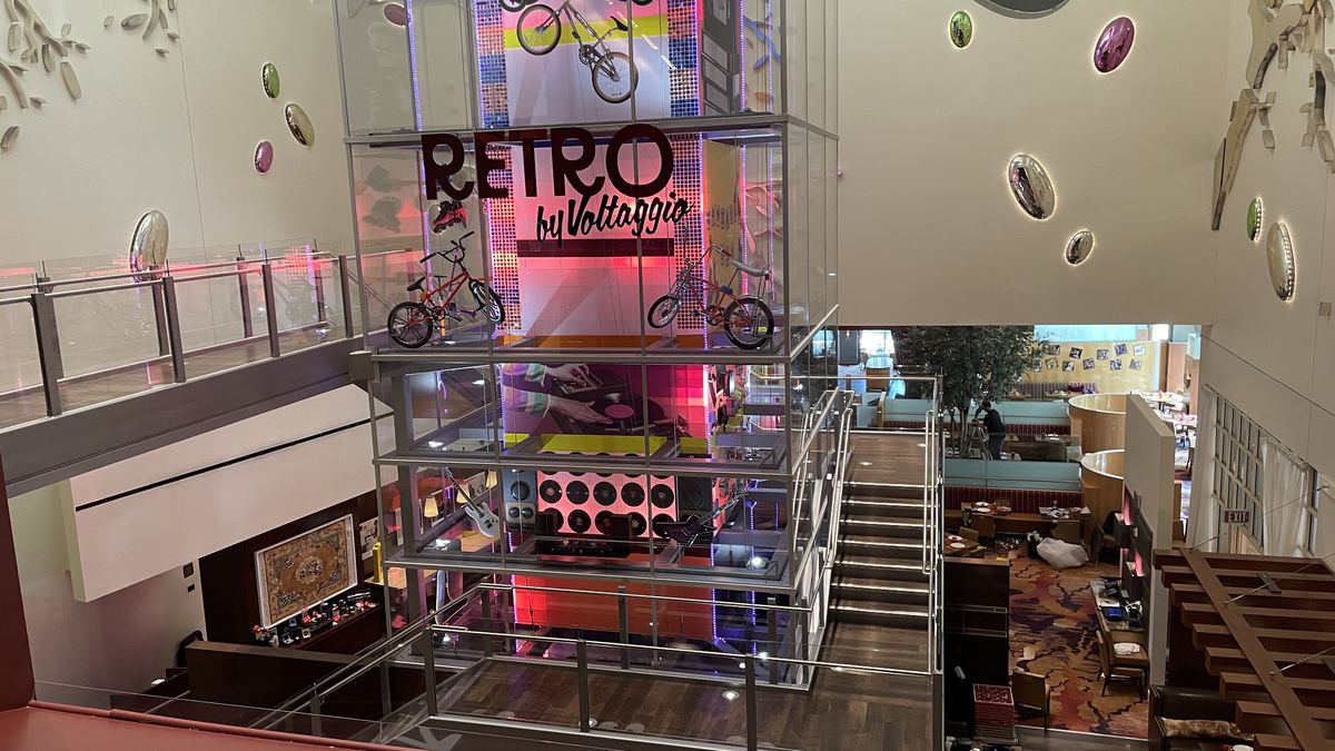A tower with ‘80s bicycles and red lighting at Retro by Voltaggio.