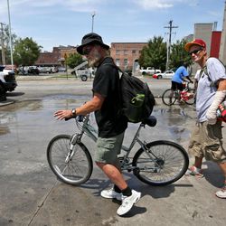 FILE "“ K.C. Collier and Larry Repass walk along 500 West in Salt Lake City as the sidewalks are being cleaned on Thursday, July 6, 2017. Collier said he can't sleep inside the homeless shelter due to bedbugs, so he chooses to sleep outside. Days after House Speaker Greg Hughes voiced frustration over the crime and chaos around Salt Lake City's troubled homeless shelter, downtown business leaders joined the chorus.