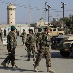 Afghanistan's National Army soldiers guard, blocking the main road to the Bagram Airfield's main gate in Bagram, north of Kabul, Afghanistan, Saturday, Nov. 12, 2016. An explosion at a U.S. airfield in Afghanistan early Saturday killed four people, the head of international forces in the country said. 