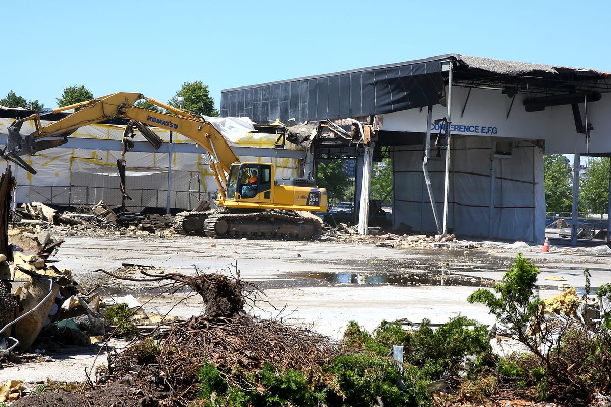 Construction equipment demolishing an old mall site.