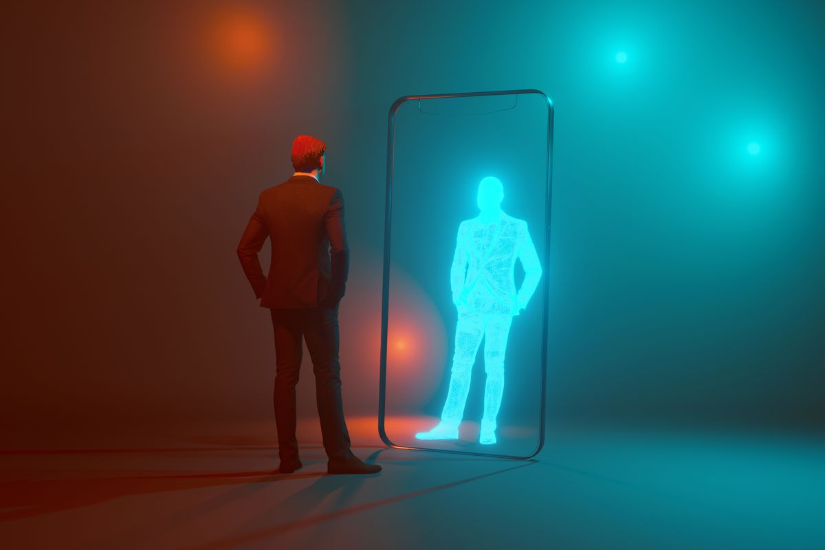 Concept image of man looking at his own digital twin mirrored through the frame of a mobile phone.