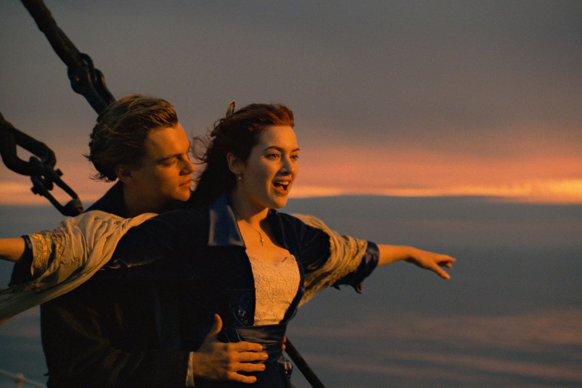 Jack (Leonardo DiCaprio) and Rose (Kate Winslet) standing atop the bow of the Titanic in Titanic.