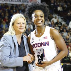 UConn’s Christyn Williams poses with Barbara Jacobs from the American Athletic Conference with her All-Freshman Team trophy.