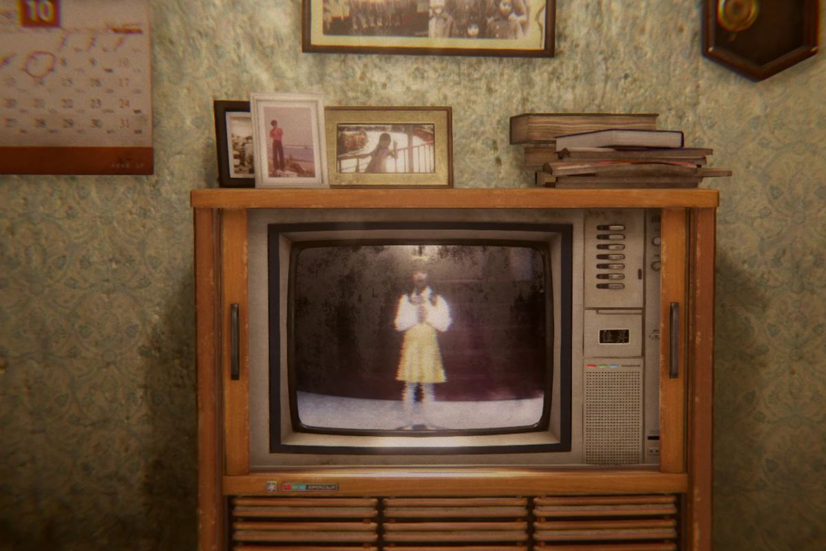 An older TV shows an image of a person singing