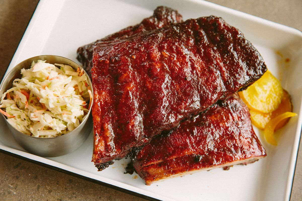 A plate of glossy red ribs with sides of slaw and pickles at the Porch in Medford.