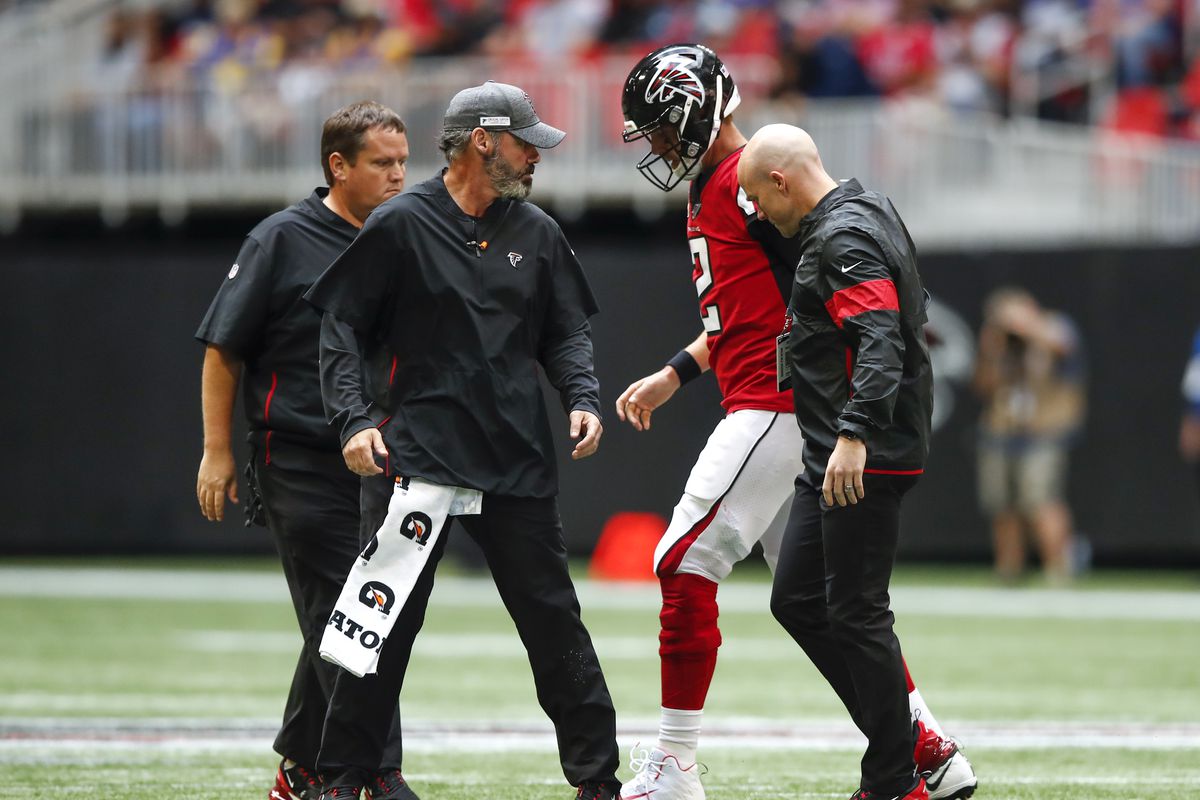Matt Ryan of the Atlanta Falcons is helped off the field following an injury in the second half of an NFL game against the Los Angeles Rams at Mercedes-Benz Stadium on October 20, 2019 in Atlanta, Georgia.