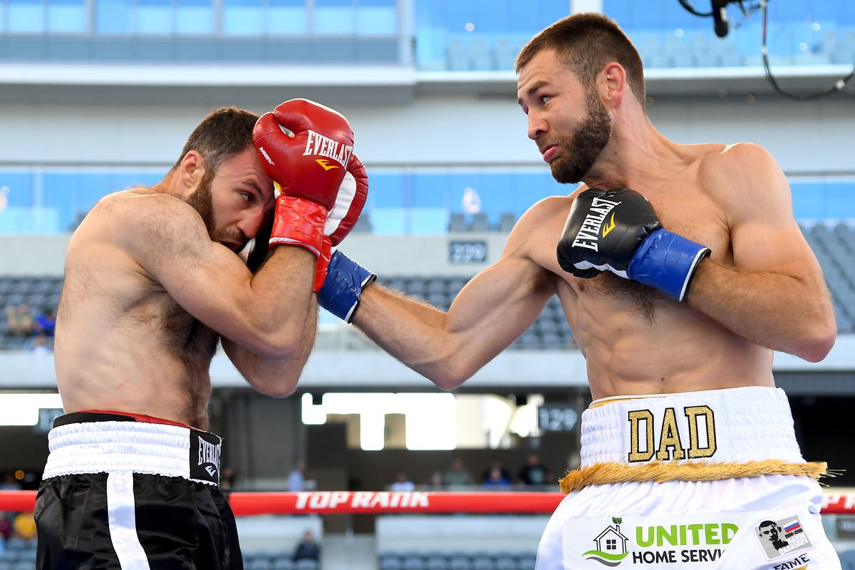 Chris Van Heerden (white shorts) and Aslanbek Kozaev (black shorts) exchange punches during their welterweight fight at Banc of California Stadium on August 17, 2019 in Los Angeles, California. Van Heerden won by unanimous decision.