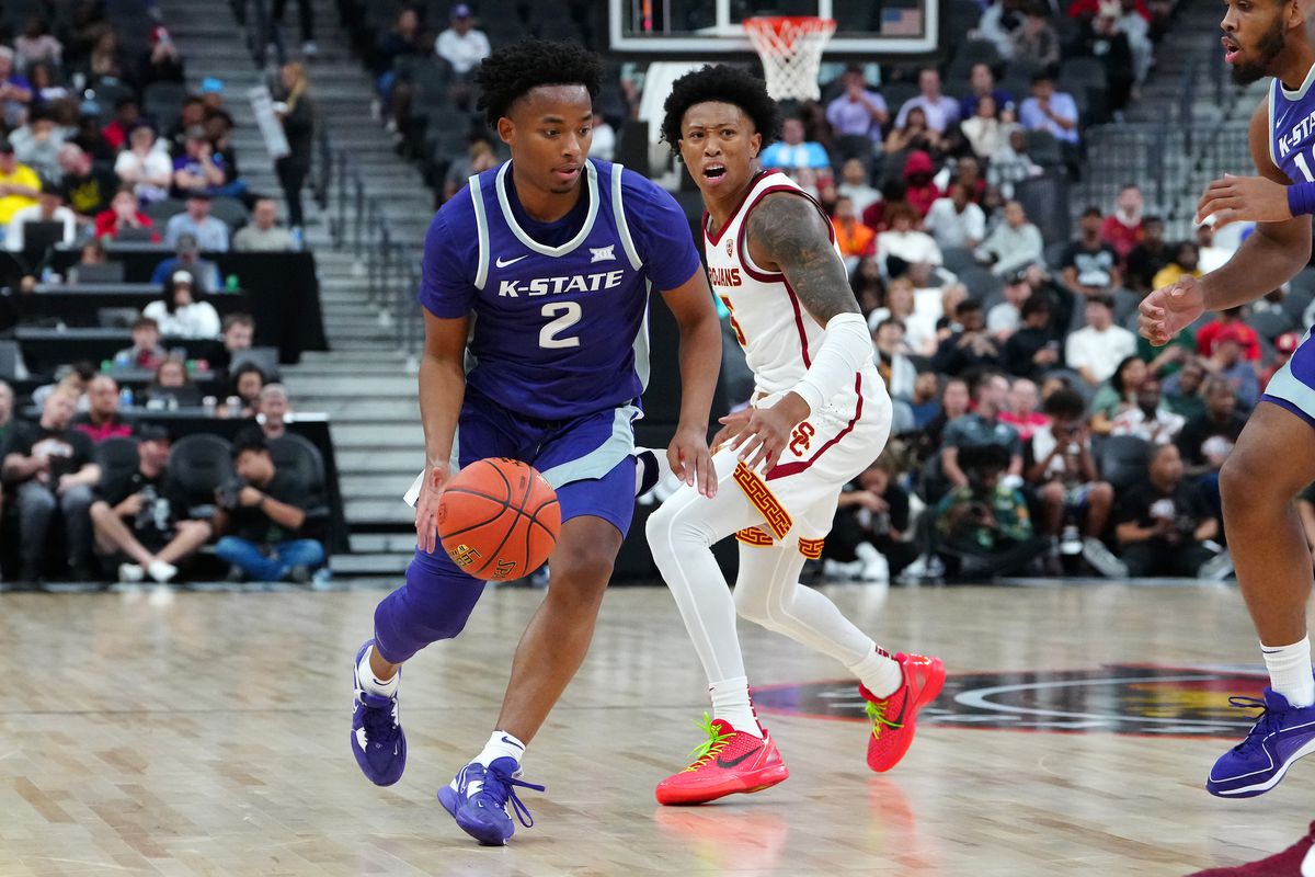 Nov 6, 2023; Las Vegas, Nevada, USA; Kansas State Wildcats guard Tylor Perry (2) dribbles against USC Trojans guard Boogie Ellis (5) during the second half at T-Mobile Arena.