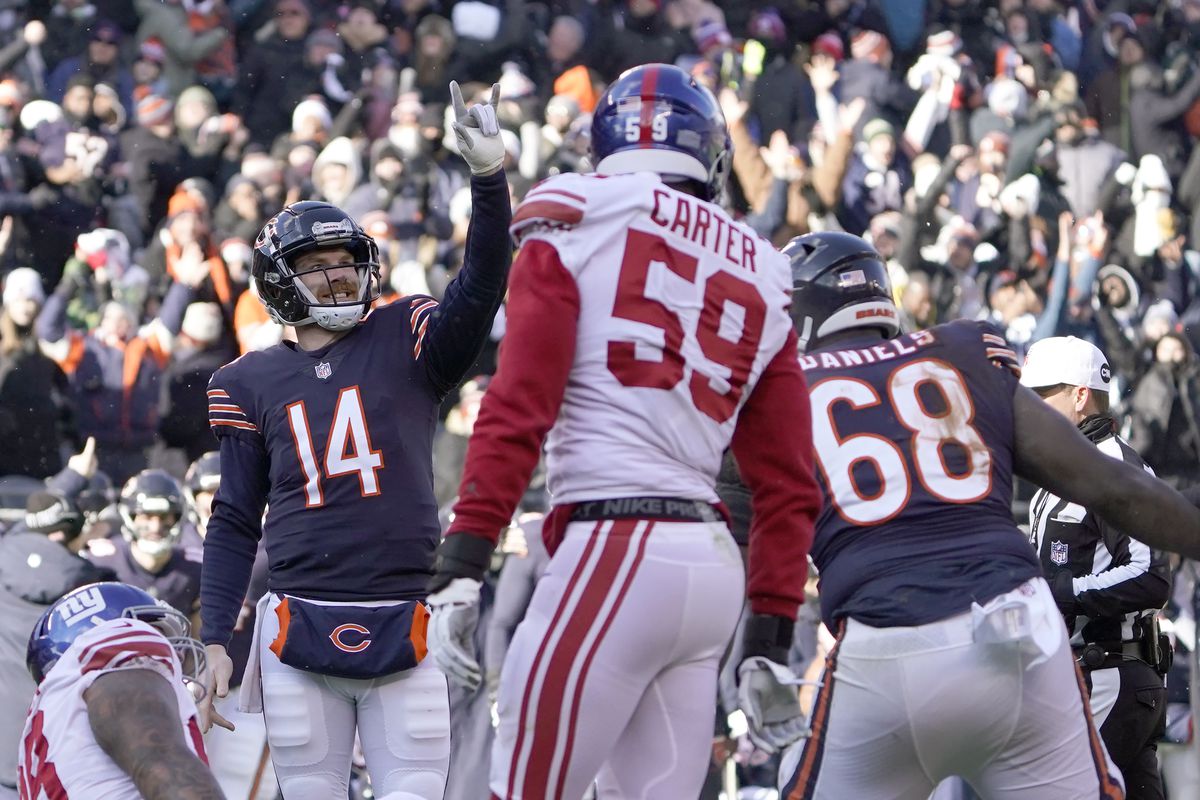 Bears quarterback Andy Dalton (14) celebrates a four-yard touchdown pass to wide receiver Darnell Mooney in the Bears’ 29-3 victory over the Giants last week at Soldier Field. 