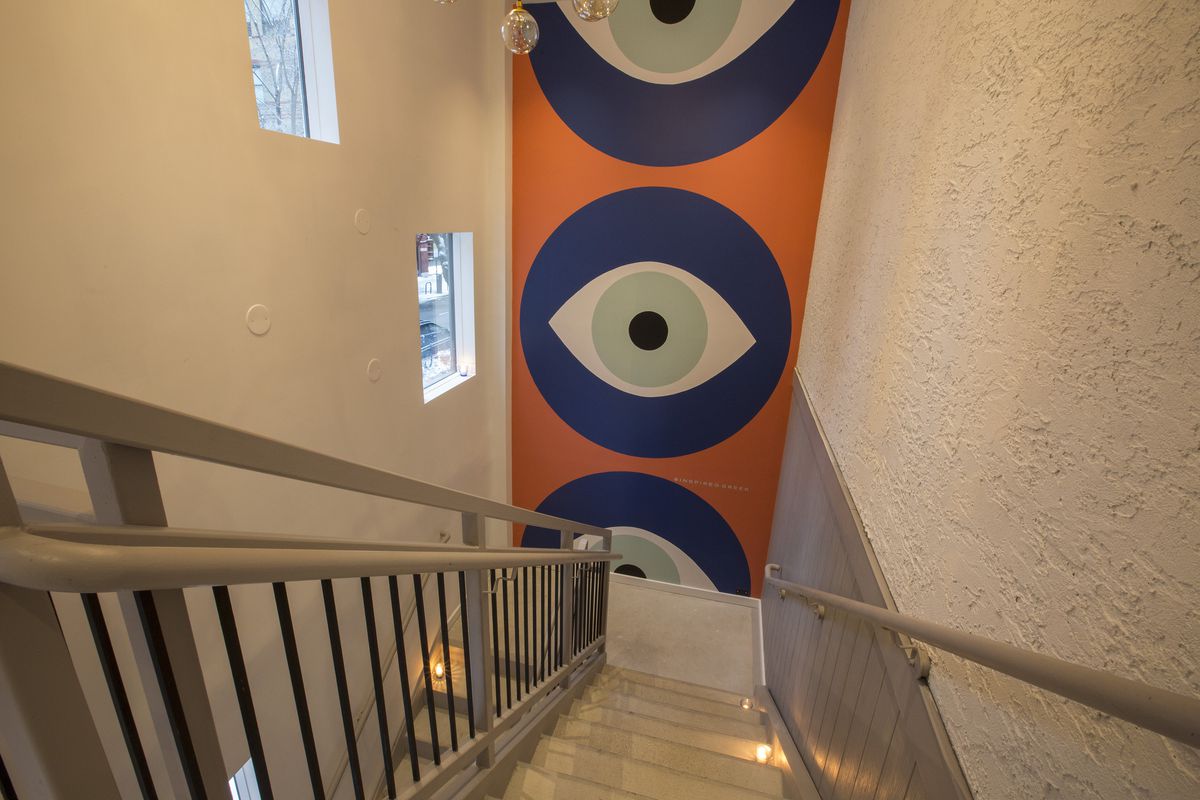 A banner of the the Greek eye down some stairs.