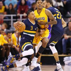 Utah Jazz guard George Hill (3) works to get past Los Angeles Lakers forward Nick Young (0) as the Utah Jazz open the home season with the LA Lakers in Salt Lake City on Friday, Oct. 28, 2016.  