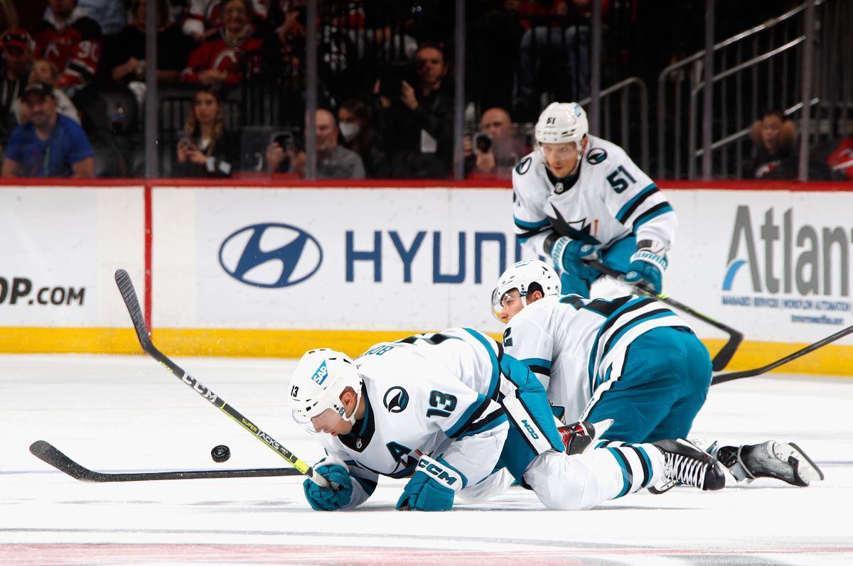 Nick Bonino #13 of the San Jose Sharks is injured and left the game on a collision with Kevin Labanc #62 during the third period against the New Jersey Devils at the Prudential Center on October 22, 2022 in Newark, New Jersey. The Devils defeated the Sharks 2-1.