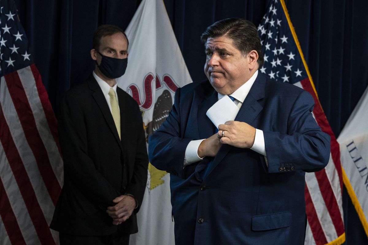 Gov. J.B. Pritzker walks away from the podium after a news conference at the Thompson Center Thursday morning.