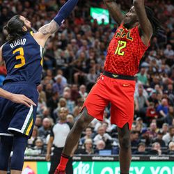Atlanta Hawks forward Taurean Prince (12) shoots over Utah Jazz guard Ricky Rubio (3) during the game at Vivint Smart Home Arena in Salt Lake City on Tuesday, March 20, 2018.