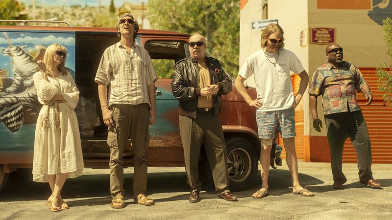 The Lodge 49 characters standing in a line outside a multicolored van.