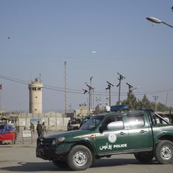 Afghanistan's National Army and police soldiers guard, blocking the main road to the Bagram Airfield's main gate in Bagram, north of Kabul, Afghanistan, Saturday, Nov. 12, 2016. An explosion at the U.S. airfield early Saturday killed four people, the head of international forces in the country said. 
