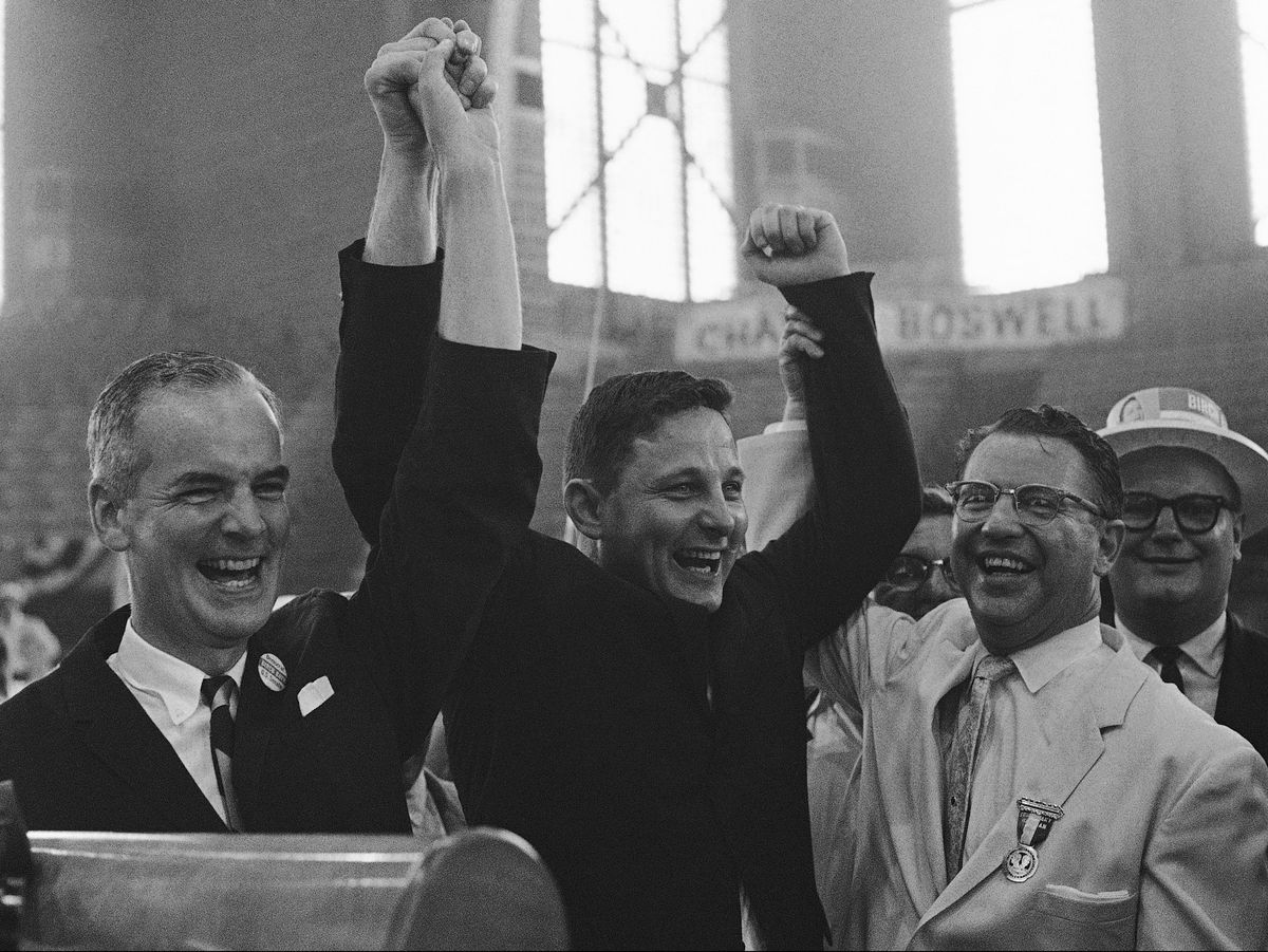 In this 1962 file photo, Indiana Gov. Matthew Welsh (left) and U.S. Sen. Vance Hartke, (right) hoist the arms of Birch Bayh Jr. in Indianapolis after Bayh won the U.S. Senate nomination at the Democratic state convention, held at the Indiana State Fairgro