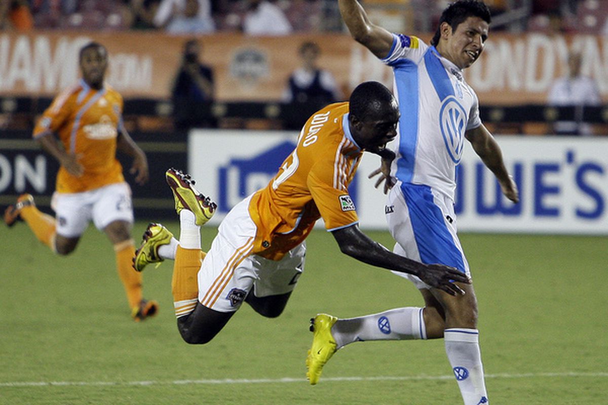 HOUSTON - JULY 21:  Dominic Oduro #23 of the Houston Dynamo is knocked off the ball by Orlando Rincon #2 of Puebla in the second half of SuperLiga play at Robertson Stadium on July 21 2010 in Houston Texas.  (Photo by Bob Levey/Getty Images)