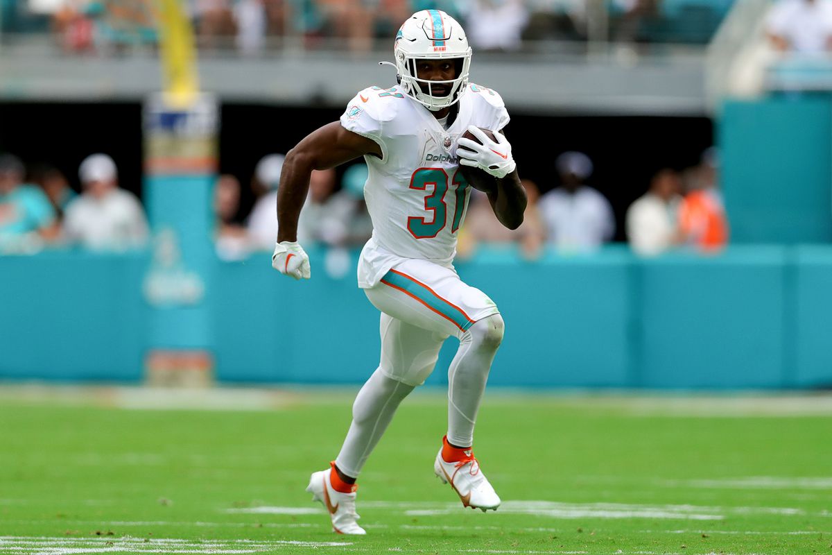 Raheem Mostert #31 of the Miami Dolphins rushes with the ball against the Cleveland Browns during the first half at Hard Rock Stadium on November 13, 2022 in Miami Gardens, Florida.