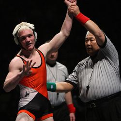 Aaron Bulter, of Monticello High School, holds up the number four after pinning Derek Herrera, of Duchesne, in the 135-pound finals at the 1A state wrestling championship at the McKay Events Center in Orem on Feb. 15, 2008. Butler became just the 17th wrestler in state history to win four titles.
