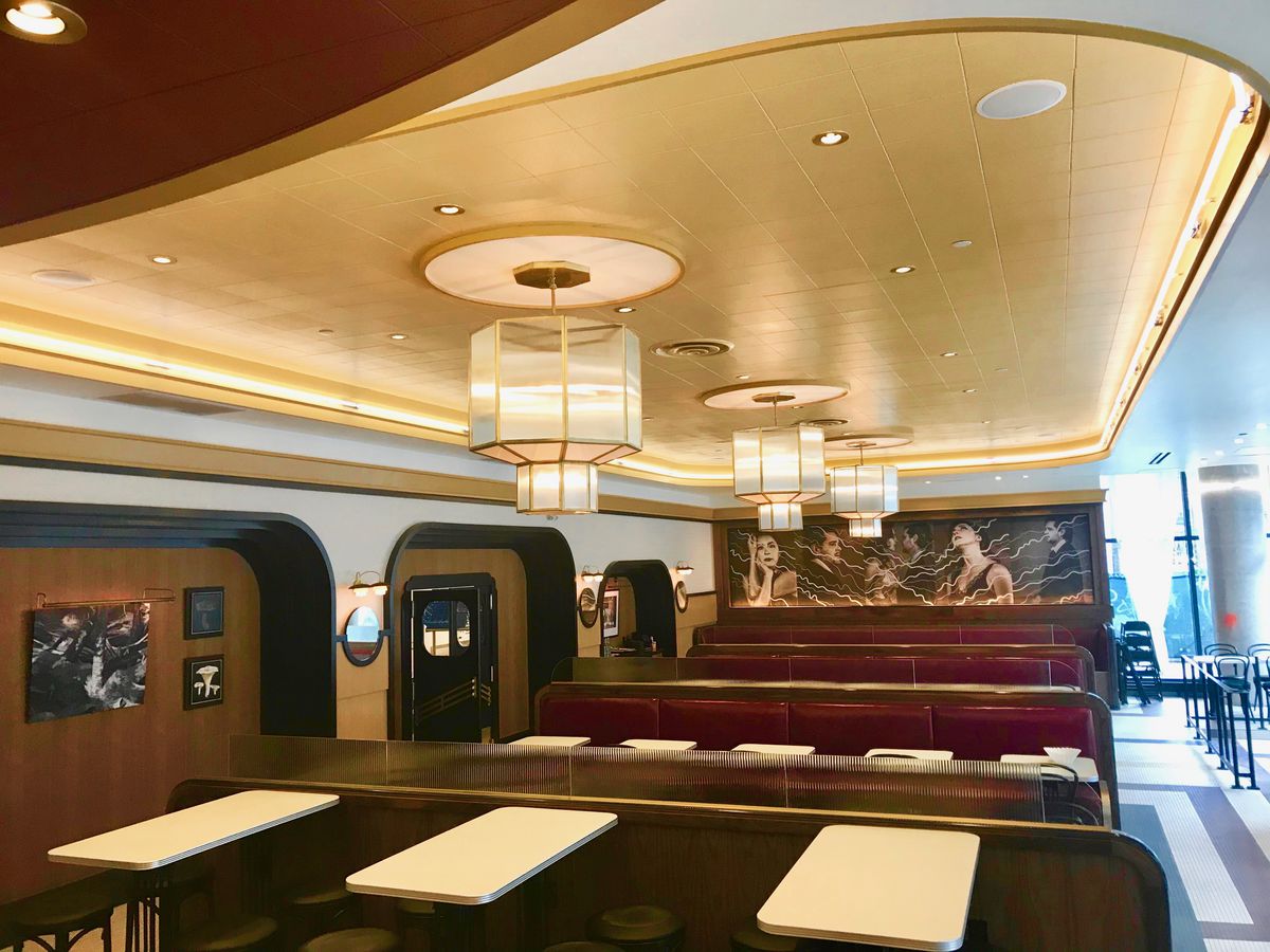 restaurant interior with red booths and art deco design