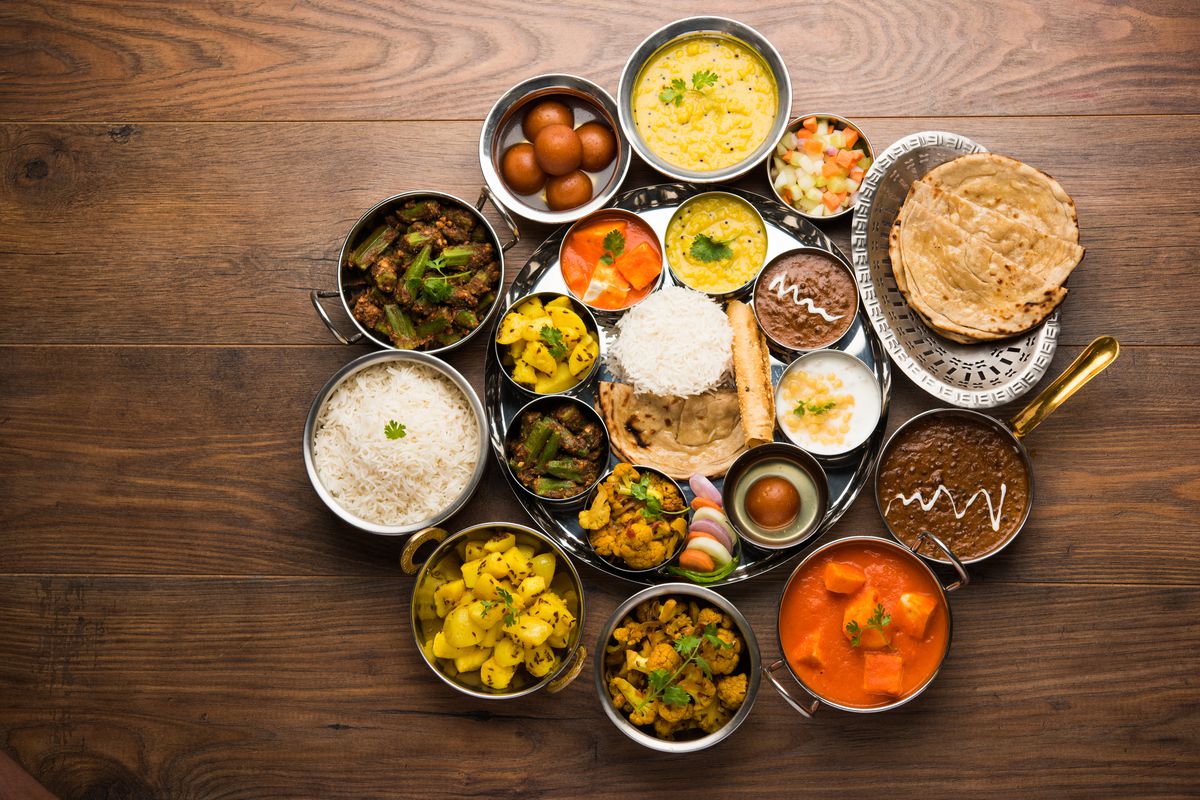 An Indian thali, an assortment of rice, flatbreads, and prepared dishes arranged on a table