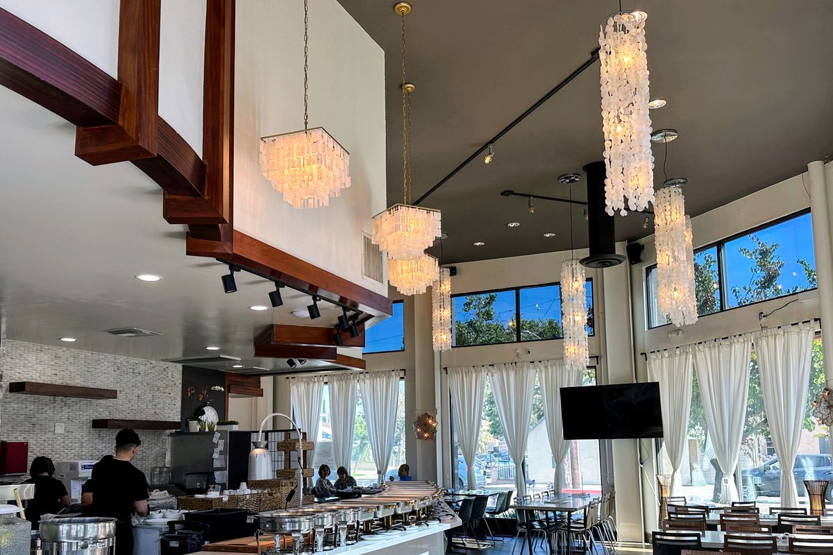 The elegant interior of Mekeni Pinoy’s Pride with chandeliers and white curtains.