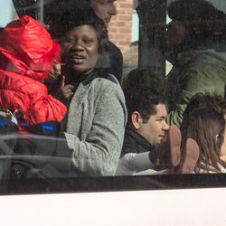People look out of a bus window after being evacuated from Brussels airport, after explosions rocked the facility in Brussels, Belgium, Tuesday March 22, 2016. Authorities locked down the Belgian capital on Tuesday after explosions rocked the Brussels airport and subway system, killing at least 34 people and injuring many more. Belgium raised its terror alert to its highest level, diverting arriving planes and trains and ordering people to stay where they were. Airports across Europe tightened security.
