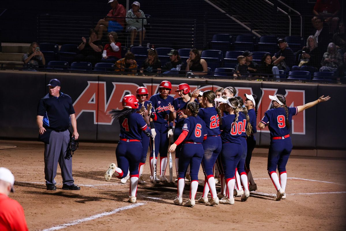 Arizona softball outfielder Dakota Kennedy is welcomed at home plate by her teammates after hitting a home run on Nov. 3, 2023