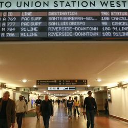 A Southern California passenger rail timetable shows the cancelled schedules of the Amtrak Pacific Surfliner at Union Station downtown Los Angeles Tuesday, Feb. 24, 2015, after three cars of a Southern California Metrolink commuter train derailed and tumbled onto their sides after a collision with a truck on tracks in Ventura County northwest of Los Angeles. 