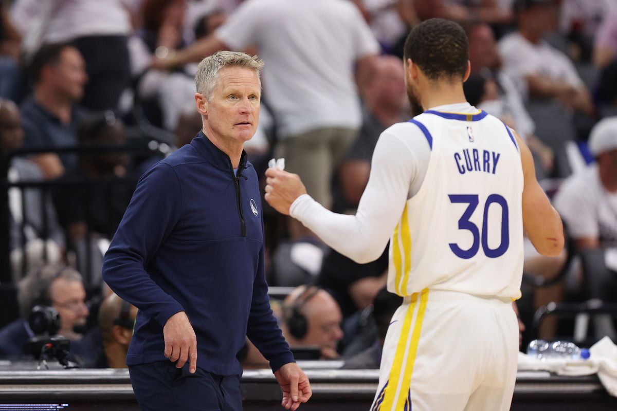 Steve Kerr talking to Steph Curry during a game
