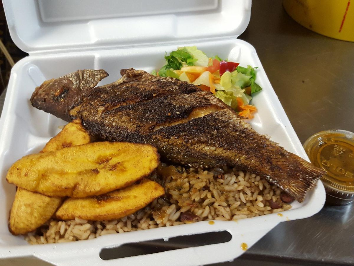 Meat, plantains, rice, and salad in a styrofoam container.