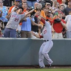 Los Angeles Angels left fielder Mike Trout reaches for a foul ball in a baseball game against the Baltimore Orioles Tuesday, June 11, 2013 in Baltimore. (AP Photo/Gail Burton)