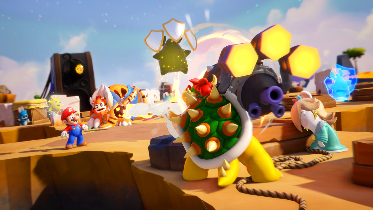 A shot from behind Bowser as he fires his “Bowzooka” at a group of enemies in Mario + Rabbids Sparks of Hope