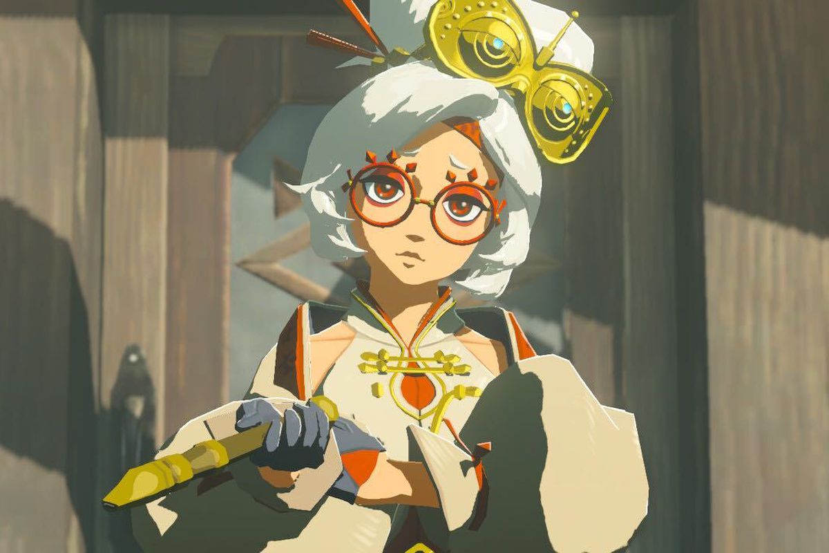An image of Purah from The Legend of Zelda: Tears of the Kingdom. She wears her hair in a big bun on top of her head. She’s looking inquisitively into the camera.
