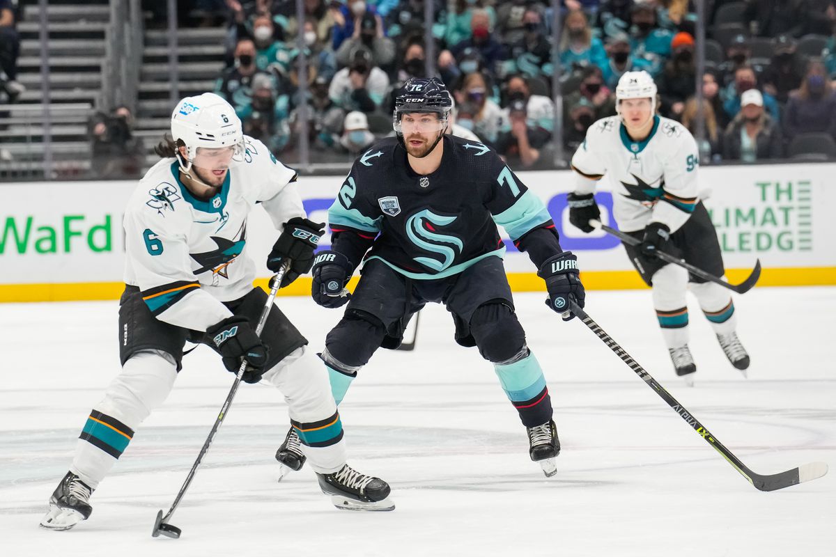 Ryan Merkley #6 of the San Jose Sharks skates with the puck against Joonas Donskoi #72 of the Seattle Kraken during the third period at Climate Pledge Arena on January 20, 2022 in Seattle, Washington.