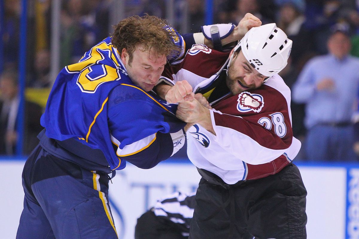 ST. LOUIS, MO - APRIL 5: Cam Janssen #55 of the St. Louis Blues fights David Koci #28 of the Colorado Avalanche at the Scottrade Center on April 5, 2011 in St. Louis, Missouri.  (Photo by Dilip Vishwanat/Getty Images)