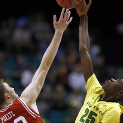 Utah Utes forward Jakob Poeltl (42) and Oregon Ducks forward Chris Boucher (25) ump in the opening tip off in the Pac-12 conference tournament championship game at the MGM Grand Garden Arena in Las Vegas, Saturday, March 12, 2016.