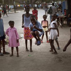 Displaced children play in the street in earthquake-torn Port-au-Prince, Thursday.