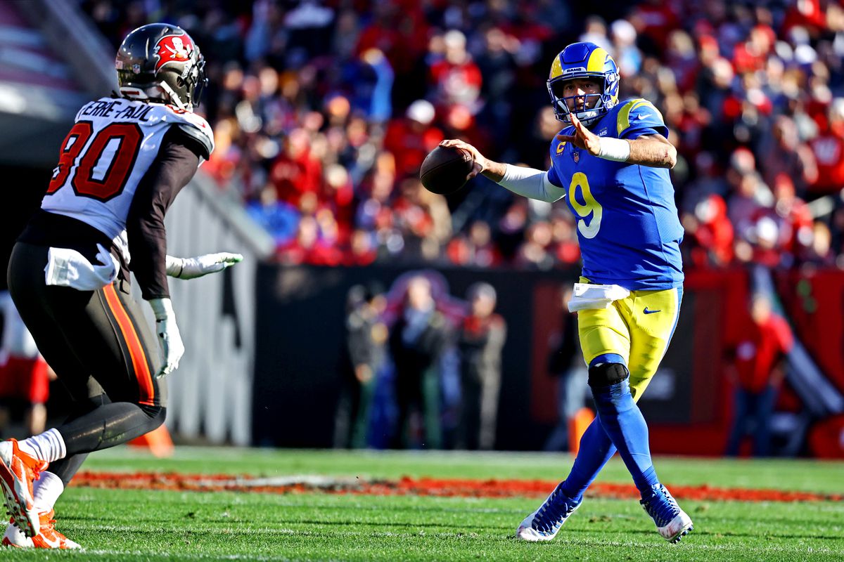 Los Angeles Rams quarterback Matthew Stafford (9) throws a pass against Tampa Bay Buccaneers outside linebacker Jason Pierre-Paul (90) during the first half in a NFC Divisional playoff football game at Raymond James Stadium.