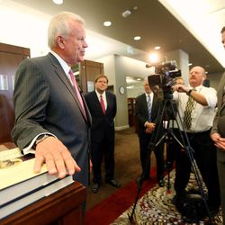 LDS Church Historian and Recorder Elder Steven E. Snow, rests his hand on a pair of the new volumes as the LDS Church, in cooperation with the Community of Christ announces the release of the printers manuscript of the the Book of Mormon, during a press conference Tuesday, Aug. 4, 2015, at the LDS Church's History library in Salt Lake City.