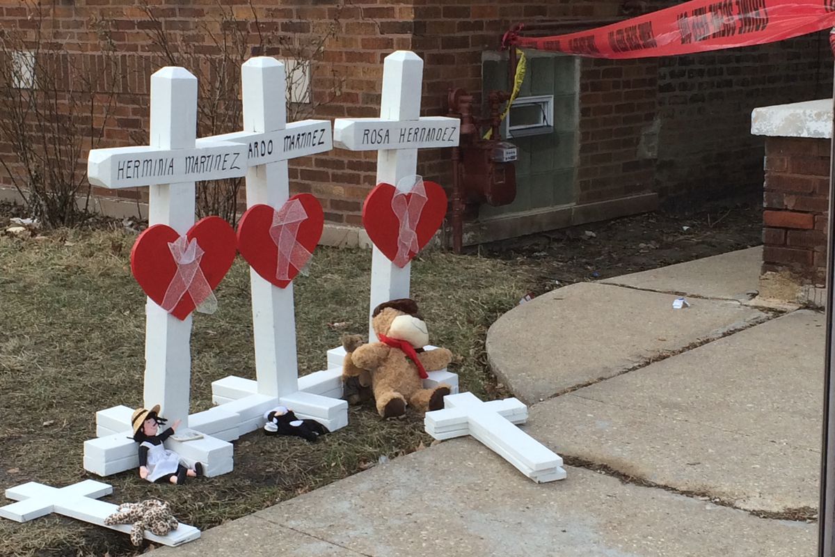 Memorial crossed lined up outside the Gage Park home of Noe Martinez Sr., who was found dead inside the house alongside his wife, and son, Noe Jr., daughter and two grandchildren, age 13 and 10.